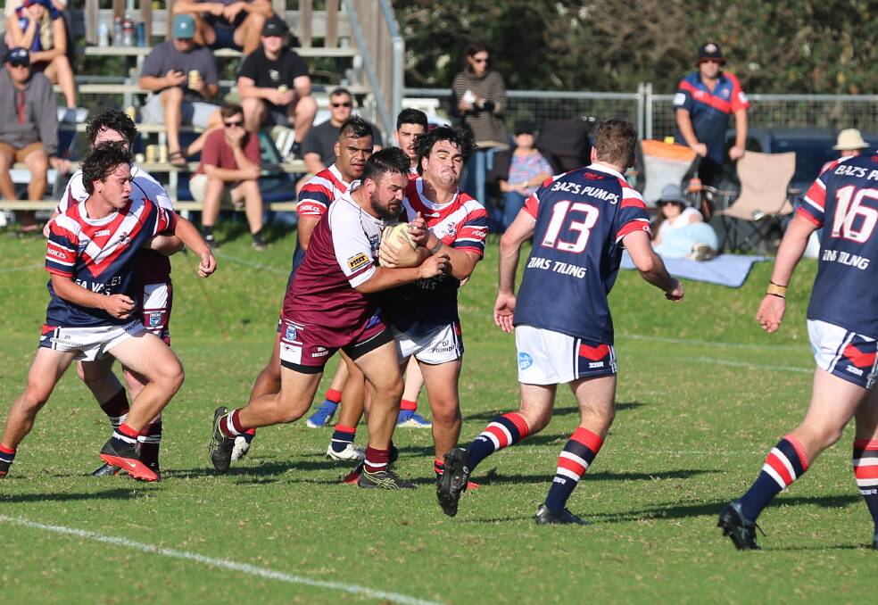 The Roosters and Sea Eagles try to out muscle each other in a tackle during their last clash earlier this season. 