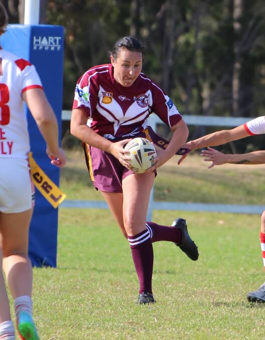 A Tathra Phoenix player evades a tackle with the team earning its first win. 