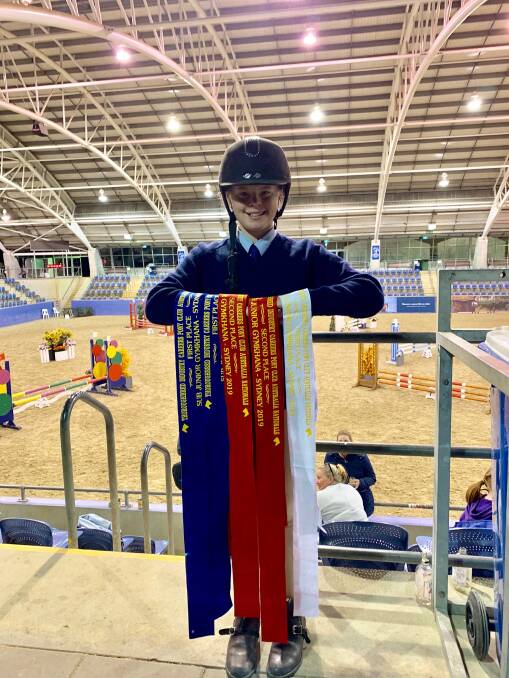 Zali Duncan with her national championship ribbons at the Sydney Equestrian Centre over the weekend. 