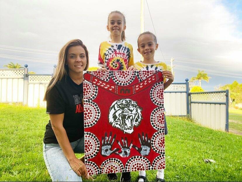Jackie, Sophia and Marli Scott with their artwork that will feature on the Eden Tigers Indigenous Round jumpers. 