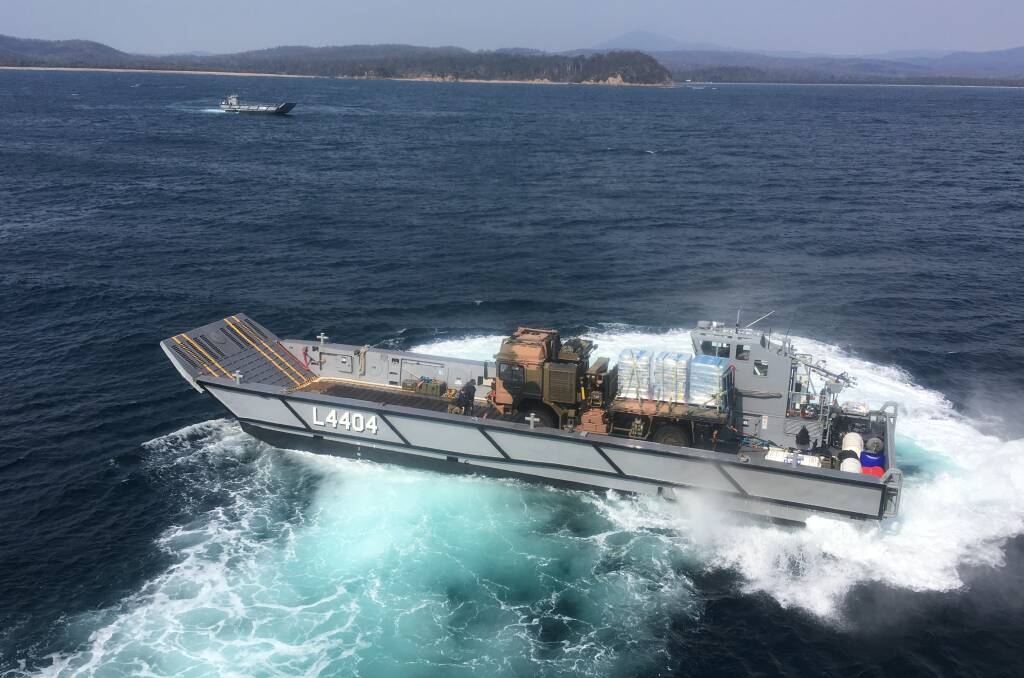 Landing craft launch from HMAS Adelaide in Twofold Bay on Friday with the largest deployment of vehicles and ground forces yet. Picture: Royal Australian Navy. 