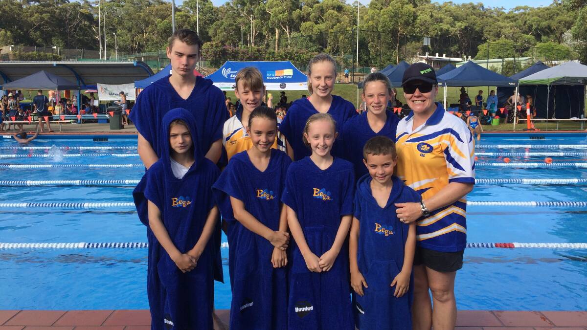 Splashing out: Bega swim coach Zoe Harris (right) with the budding group of competitors who raced at Ulladulla over the weekend in the Speedo Sprints and the SESA championships. 