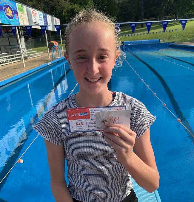 Bega Swimmer of the Month Brooke Smith accepts her voucher. 