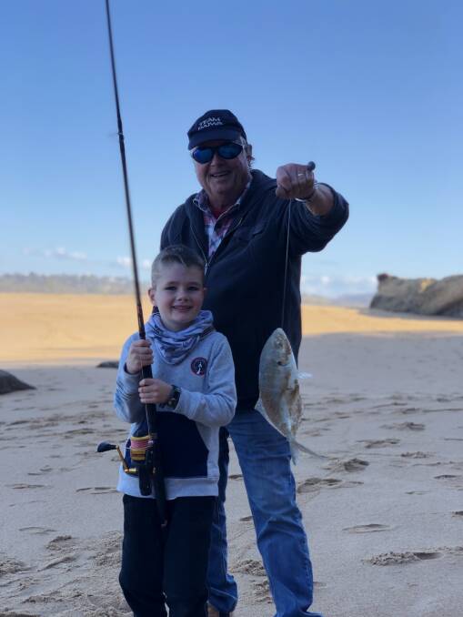 Great catch!: In the good hands of his grandfather Ken McCoombe, six-year-old Oscar Dixon from Torquay, Victoria shows his first ever trevally taken at Mogareeka.