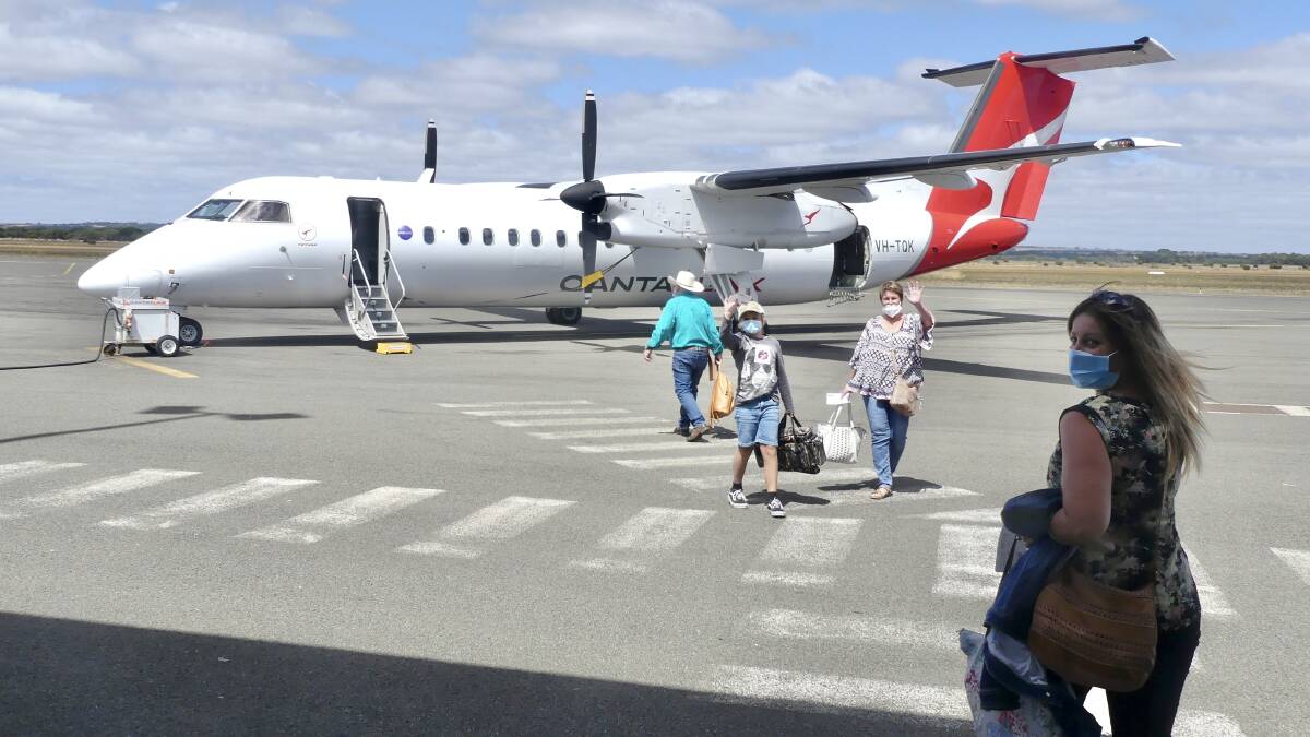 ADELAIDE FLIGHT: Passengers depart Kingscote, Kangaroo Island on a Wednesday flight to Adelaide on the Qantas Q400 flight. There are now double flights on Mondays and Fridays. Photo: Stan Gorton 
