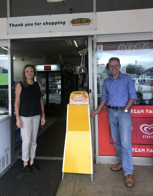 INITIATIVE: Tathra Friendly Grocer's Nicole Dowdle with general practitioner and anaesthetist Duncan Mackinnon and one of the emergency hand washing stations.