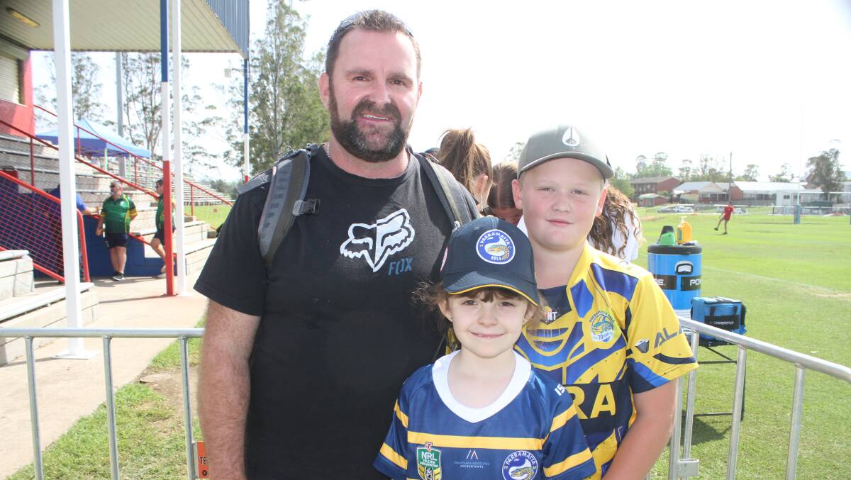 FANATICAL: Die-hard Parramatta Eels supporter Mark Smith with his daughter Chellah and nephew Kye in Bega on Friday. Picture: Alasdair McDonald