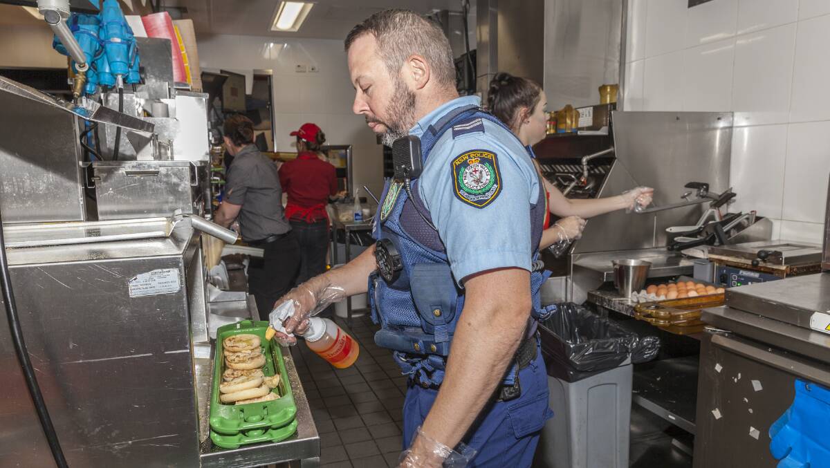Police officer Tim Morrow in the kitchen for McHappy Day on Saturday. Picture: Phillip Hayson