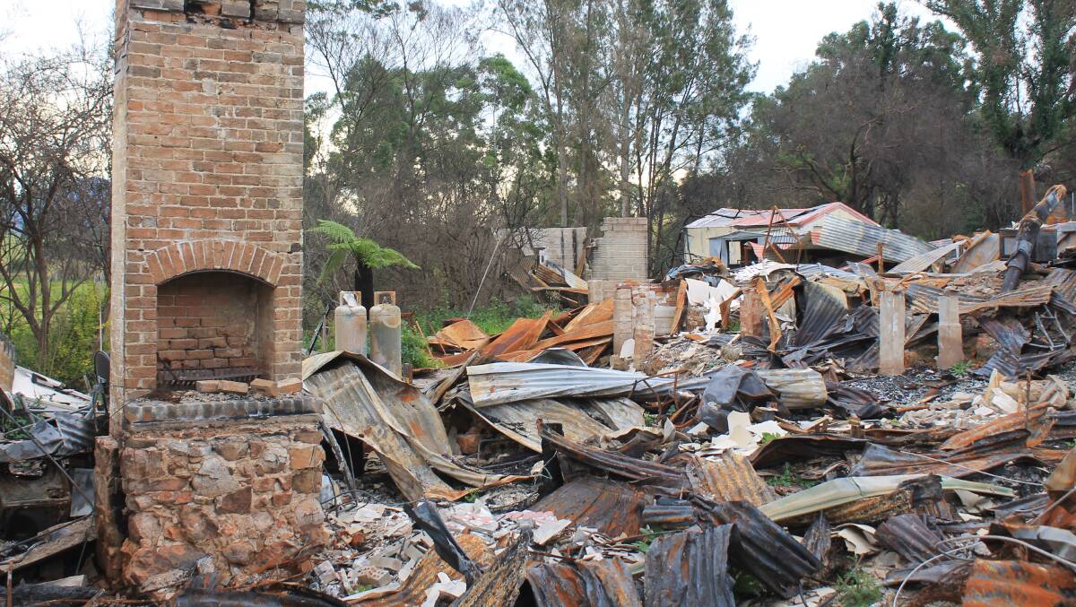 The state government has starting its cleanup of Cobargo four months after fire tore through the town. Picture: Albert McKnight