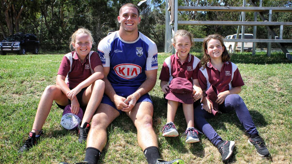 Junior Sea Eagles players Mali Whatmore, Eloise Wallace and Ruby Blankenstein with former Sea Eagle and current Canterbury-Bankstown forward Adam Elliott. Picture: Alasdair McDonald
