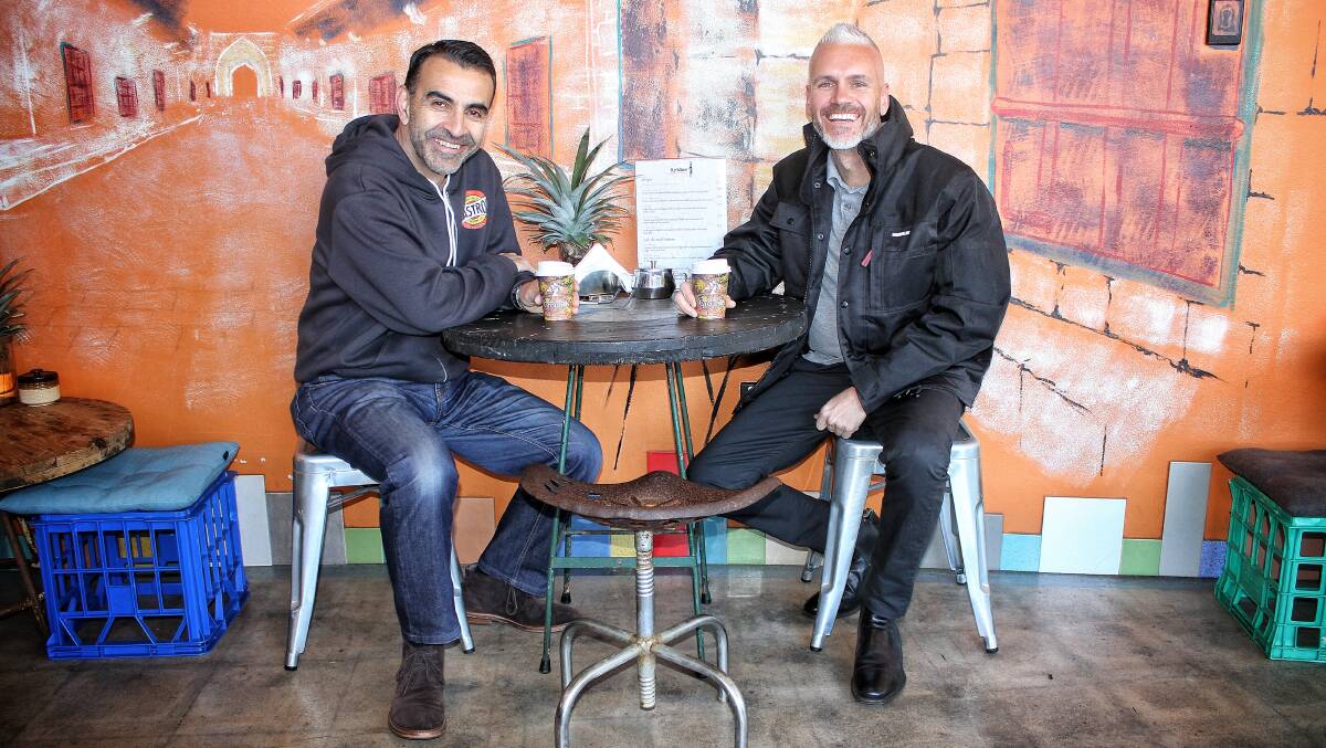 BUY LOCAL: Tarra Motors director John Stylianou with Australian Community Media sales manager Tim Shinnick at Byblos Phoenician Street Food cafe in Bega. Picture: Alasdair McDonald