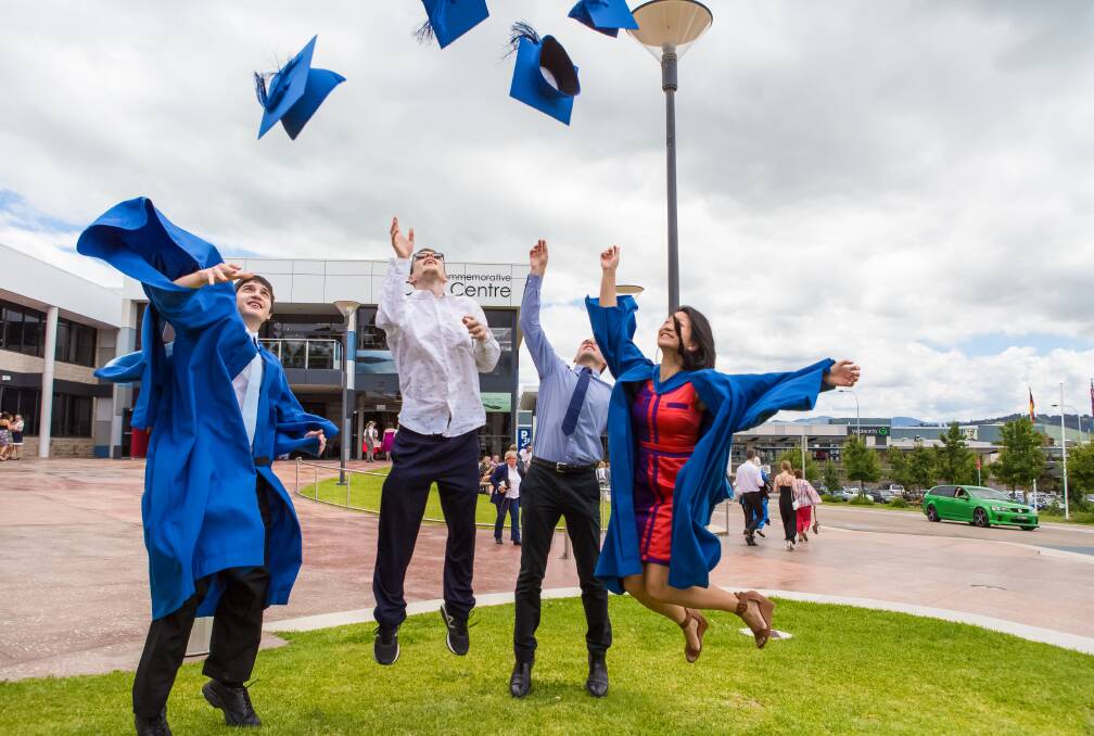 EXCITED: University of Wollongong Bega campus students celebrate their graduation outside the Bega Valley Commemorative Civic Centre on Friday. 