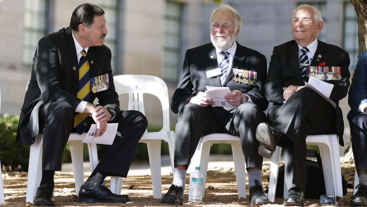 CYBER BATTLE: Eden-Monaro MP and shadow Assistant Minister for Defence Industry and Support Mike Kelly meets with Battle of Atlantic veterans Douglas Gilling and Don Kennedy during the 75th anniversary commemorative service at the Australian War Memorial in Canberra in May. Photo: Alex Ellinghausen