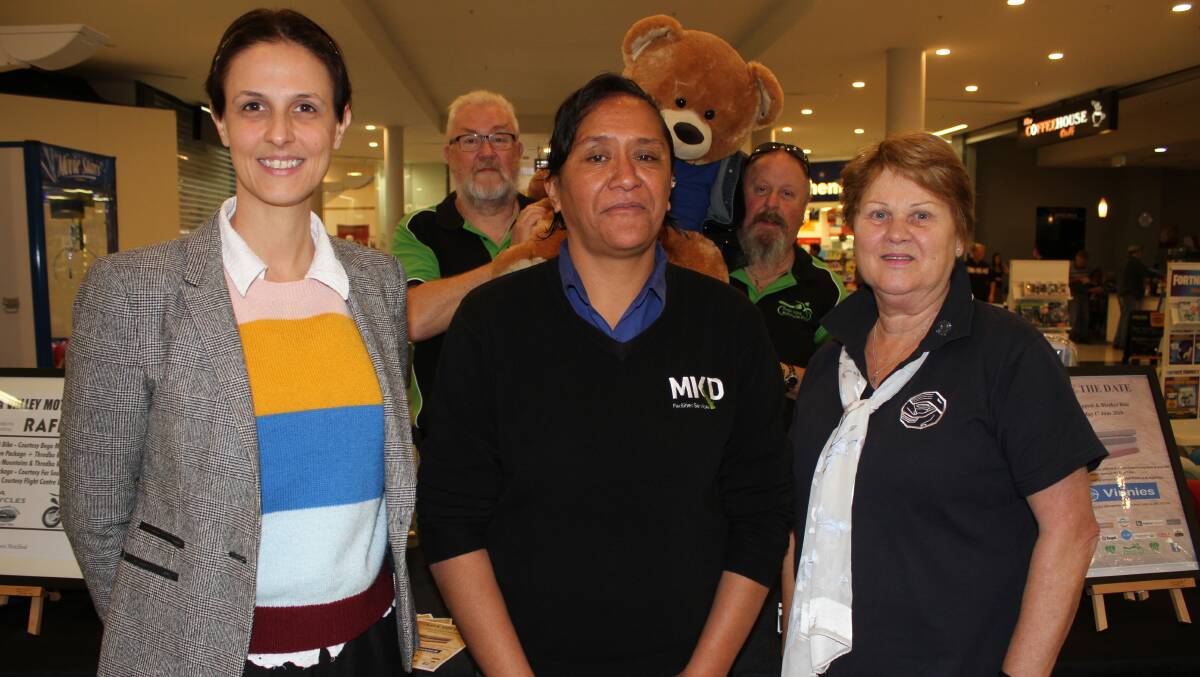 Sapphire Marketplace centre manager Emma Boyle with site supervisor Judy Wilson, St Vincent de Paul Danni Koenigkamp and Bega Valley Motorcycle Expo's George Parker and Glenn Cotter (back) holding Vincent the bear. Picture: Alasdair McDonald