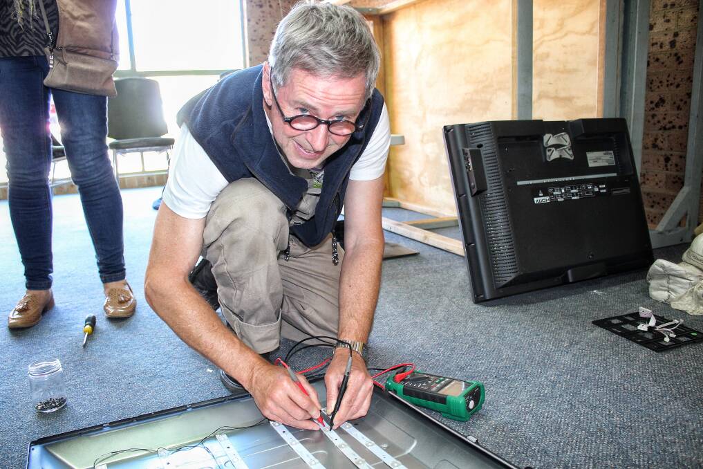 FIX IT: Tathra's David Neyle with a flat screen television at the recent launch of the Bega Remakery at Funhouse Studio. Picture: Alasdair McDonald
