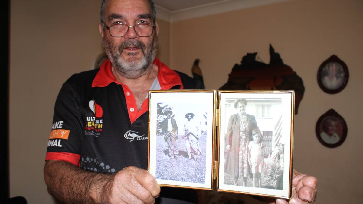 Barry kelly holds a photograph of Helen de Mestre (standing on the right in the left photograph) taken while holding a boomerang at Wallaga Lake.