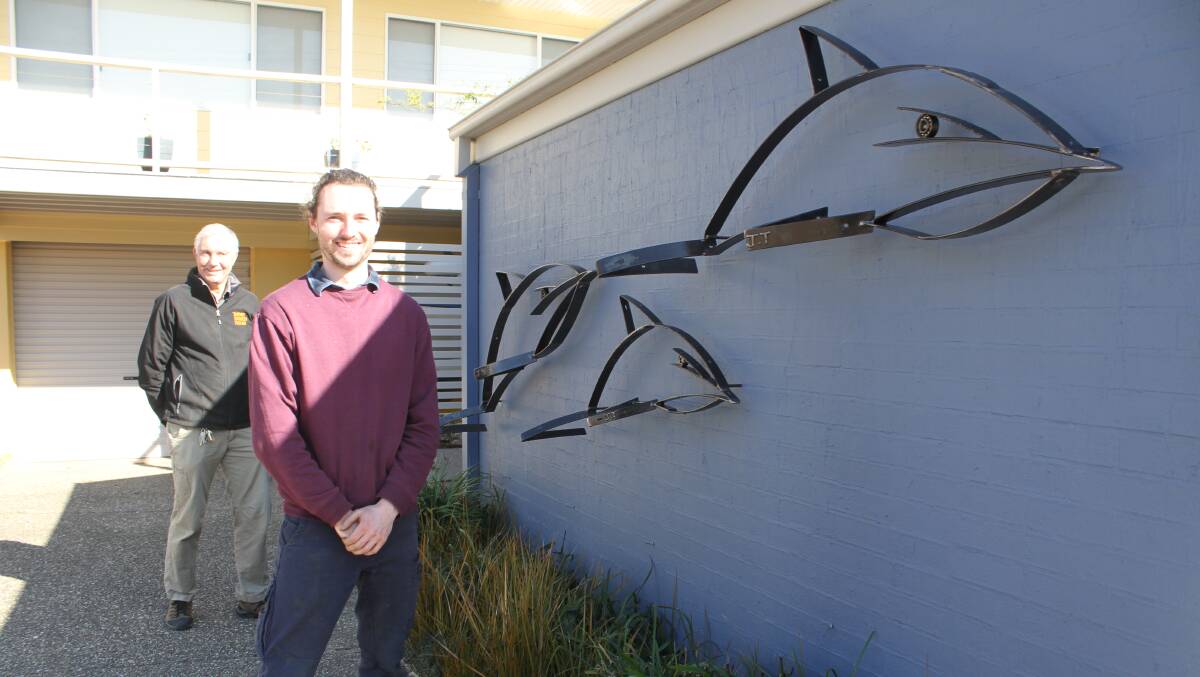 MARINE THEME: Tathra Beach Side Apartments owner Rob White with Jordan Tarlinton's newly installed work on Friday. Picture: Alasdair McDonald