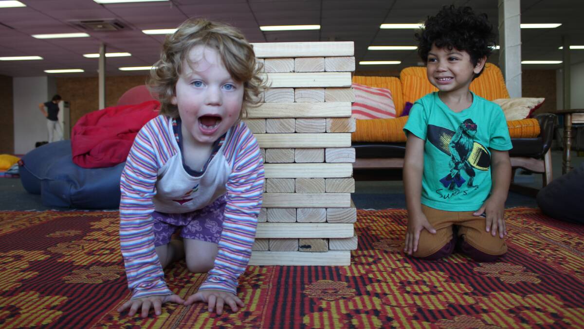GIANT JENGA: Orlo Lynnah and Hiro McDonald with just one of the many games on offer as part of Funhouse Studio's Free Fun Village Games at the Candelo Village Festival on Sunday morning.