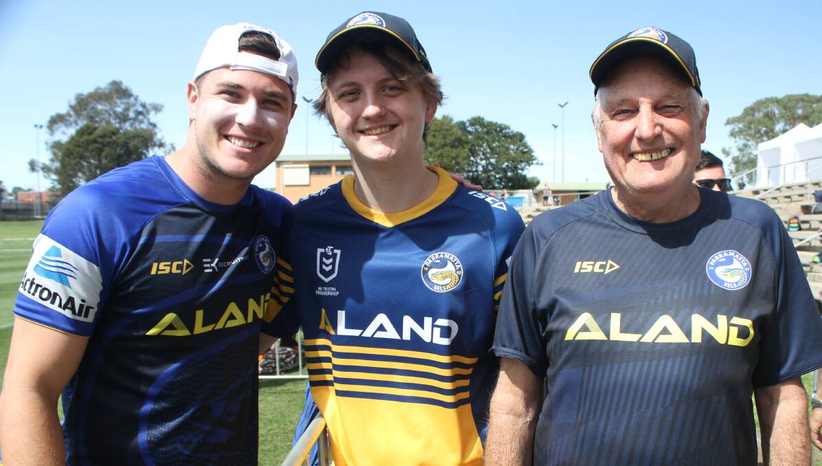 Superfan Mitchell Geeson (middle) with his favourite footballer Mitch Moses (left) and his grandfather Warren Kreckler. Picture: Alasdair McDonald