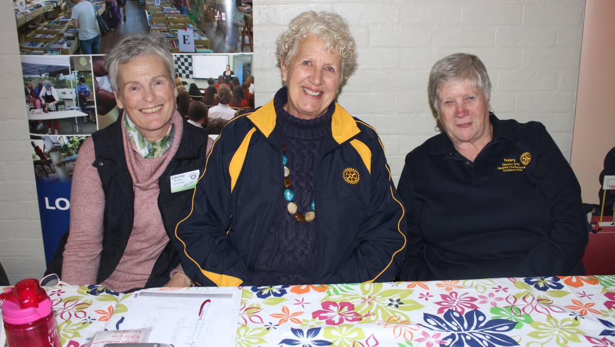 BUSY: Rotary Club of Bega's Leonie Blomfield and Jan Southcott and Beth Walters at the Bega Showground pavilion on Friday. Picture: Alasdair McDonald