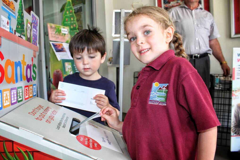 Numbugga's Lilian Armstrong and her brother Lucas drop their letters into Santa's Mail Box this week. 