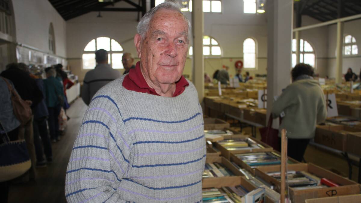 FICTION FAN: Peter Rogers sifts through the fiction section of the Rotary Club of Bega's book fair fundraiser on Friday. Picture: Alasdair McDonald