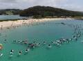 Hundreds of paddlers join an event at Narooma's Bar Beach to protest a fishing amnesty within Batemans Marine Park sanctuaries.
