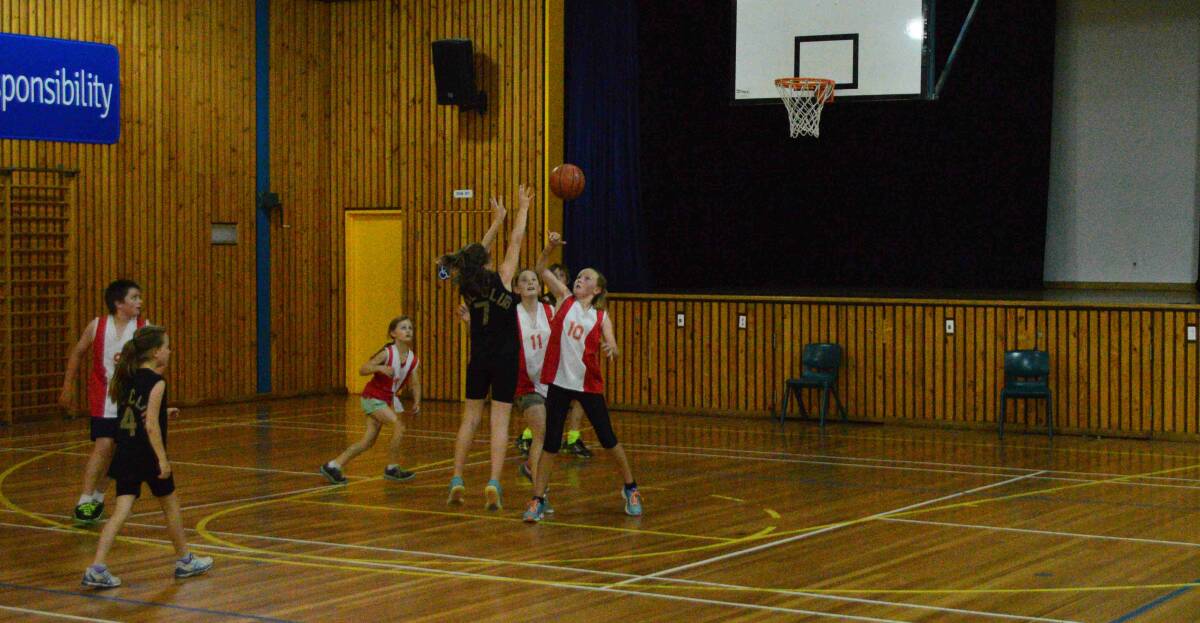BOMBALA BASKETBALL: In the ladies basketball the Black team drew with the Red team 26 all. Paige Hurley shooting and Zara Badewitz defending.