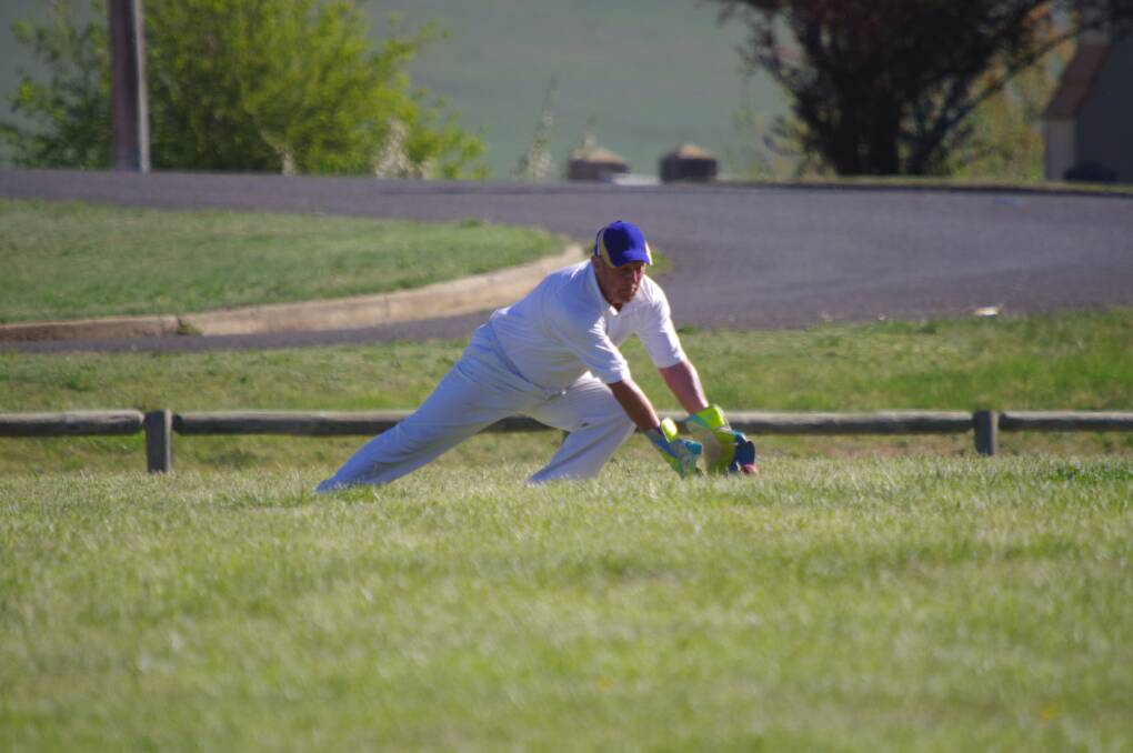 Bombala wicket keeper Peter Jones stretches for the ball during Saturday's inaugural game for Bombala against Dalgety at Nimmitabel.
