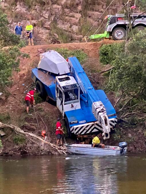 Two large mobile cranes were called to salvage a mobile crane that had slipped off Eurobodalla Road and rolled into the Tuross River late last year. Photo: K Colburn