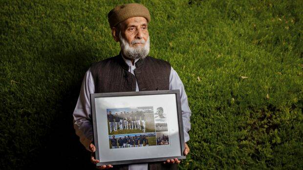 Muhammad Akbar Abbasi with photos of his son Zeeshan Akbar, who was tragically killed on April 7 while working at a service station in Queanbeyan. Photo: Sitthixay Ditthavong