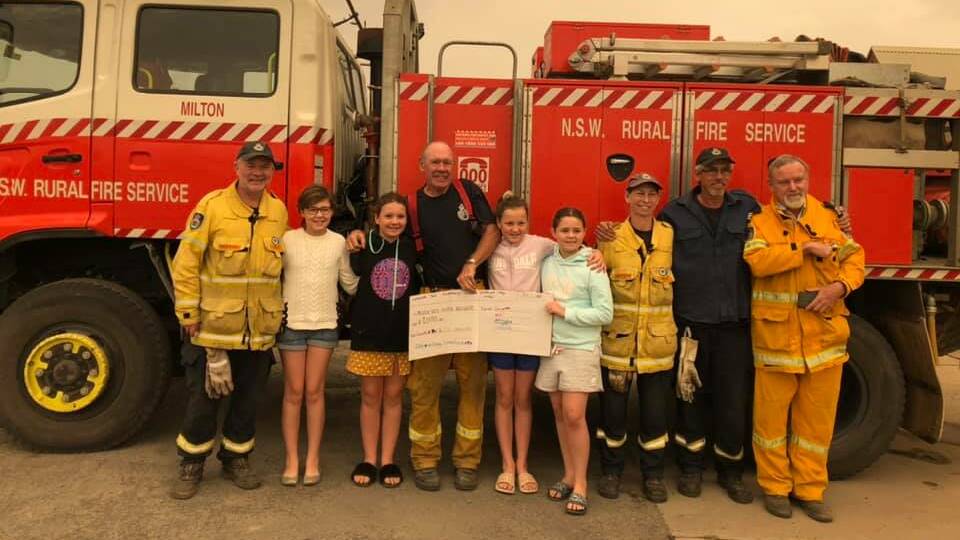 Charlotte and Izzy Unsworth, Ellie and Jassy Comerford with Milton Rural Fire Service volunteers. Picture: NSW RFS Milton Brigade.