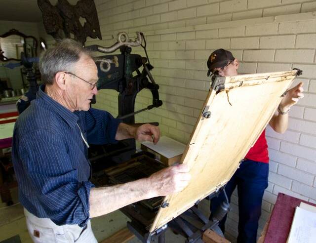 Richard and Megan checking the proof of the Boydtown Standard, printed on the Columbian hand press. Photo: Sandy Hart
