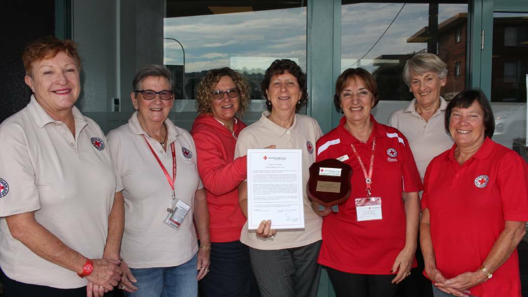 Merimbula team Red Cross volunteers Jenny Balfe, Di Petty, Sharon Tapscott, Helen Williamson, Loretta Fella, Jenny Robbins and Sue Muffler with Red Cross Distinguished Team Award in recognition of the work they did during, and following the Tathra district's bushfires in 2018.
