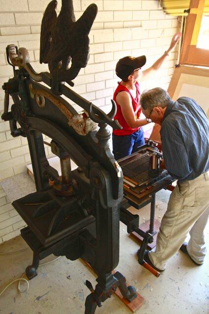 Richard and Megan working the Columbian hand press. Photo: Sandy Hart
