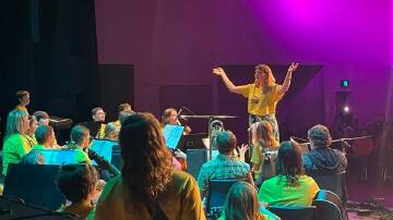 Eden Marine High School teacher Harriet D'Arcy leading the concert band at the music camp. Photo supplied