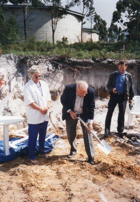 The photo shows Mayor Mick Allen, turning the first sod of Nullica Lodge with committee people, Pat Miles (L) and Jack Dickenson (R) looking on. Photo supplied