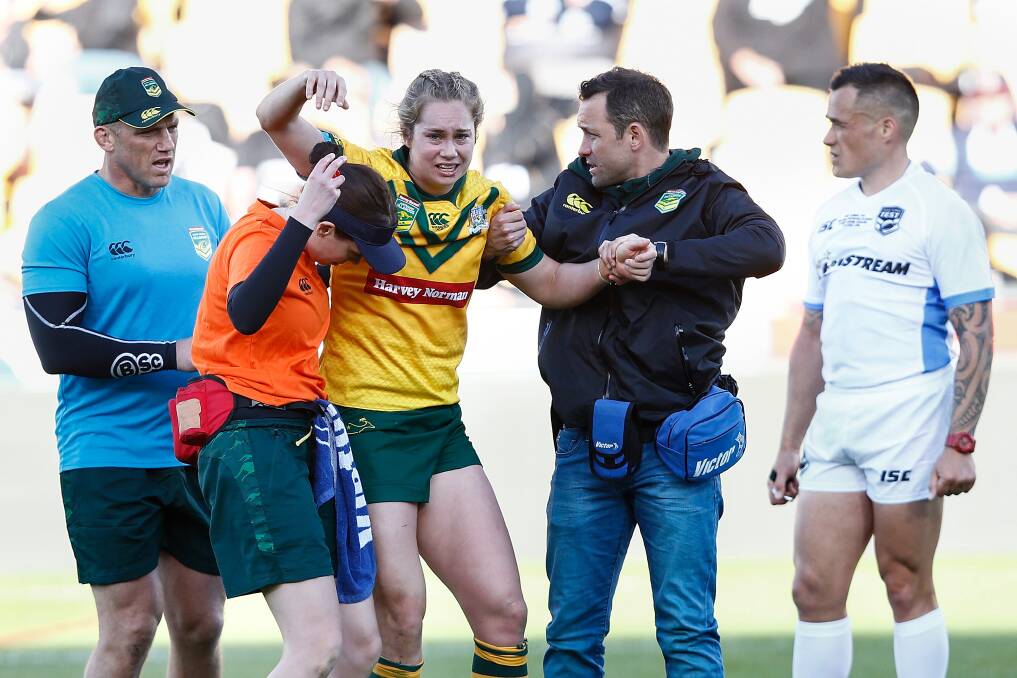 OUCH: Jillaroos star Kezie Apps is helped from the field after fracturing her fibula in Australia's Test win over New Zealand. Picture: AAP Image