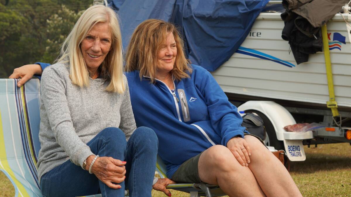 Shirley Green, visiting from South Africa, with Cara Page, of Fadden, ACT. They evacuated from Guerilla Bay. Picture: John-Paul Moloney