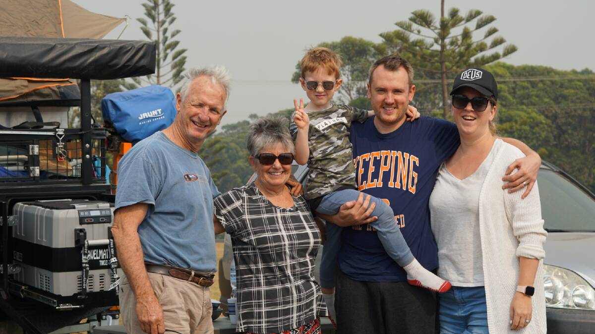 Mark and Sandra Carmody, of Gundaroo, with Jesse, 4, Jonathan and Jo Taylor, of Sydney. They were at campsites next to each other at Batemans Bay and then reunited by chance at Ulladulla evacuation centre. Picture: John-Paul Moloney