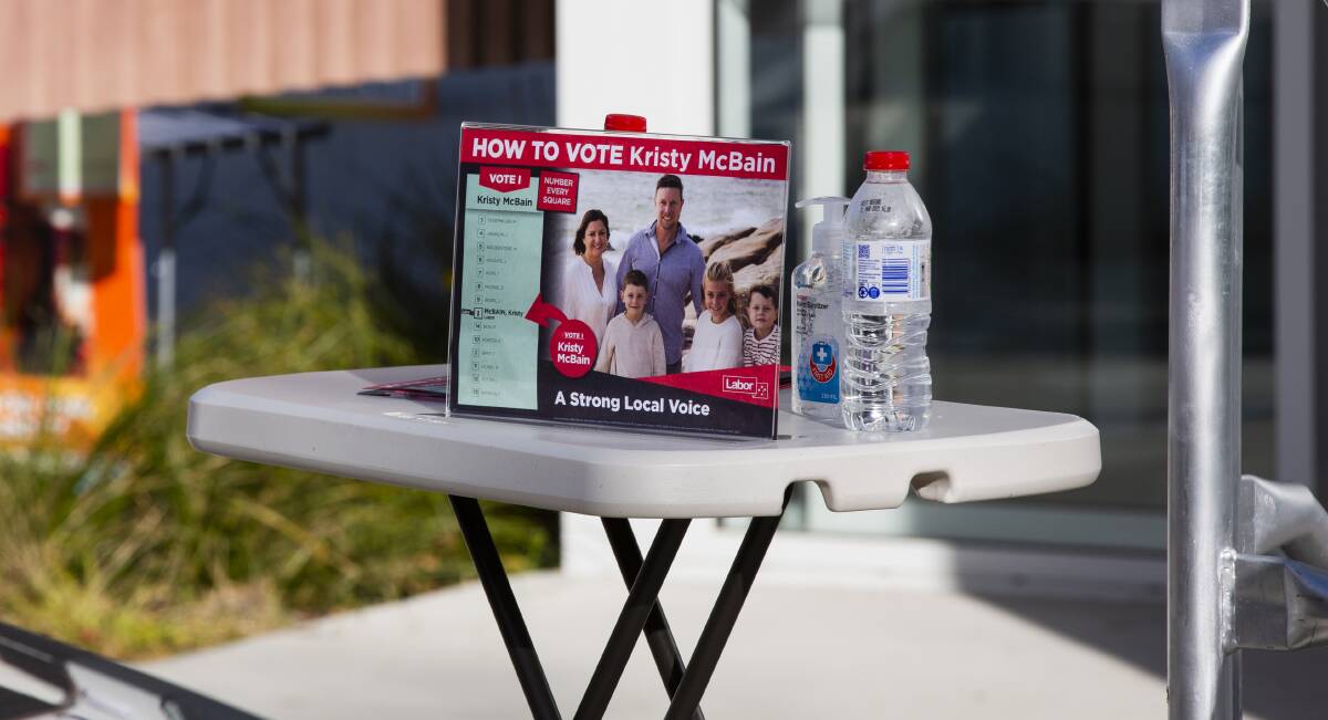 Labor how-to-vote cards and hand sanitiser greeted voters at the Queanbeyan early voting centre on Monday. Picture: Jamila Toderas