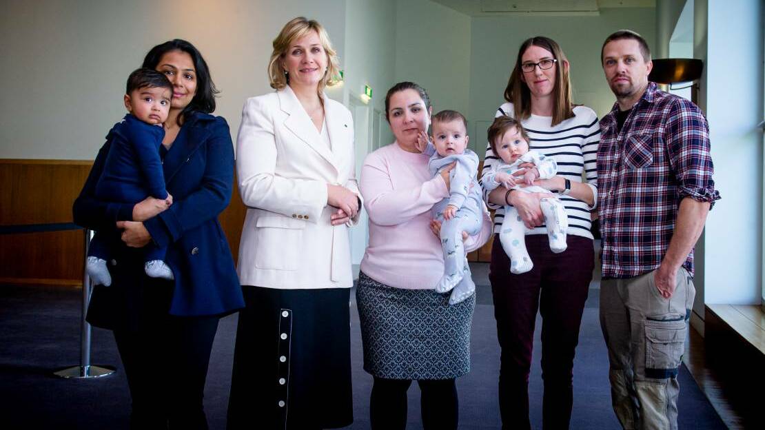 Canberra parents including Paul and Sophie Robinson with baby Lucy (far right) came to parliament last month to call for non-citizen parents to be allowed to visit family in Australia. Picture: Elesa Kurtz
