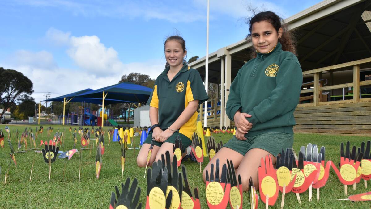 HANDS: Lani Cocks and Taylah David among the hands planted with NAIDOC Week messages at Port Lincoln Primary School.