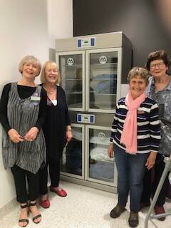 Pam Jordan and Bev Slater from Tathra Auxiliary with Lyn Murphy and Anne Sheedy from Bega Auxiliary inspect the new Blanket Warmer.