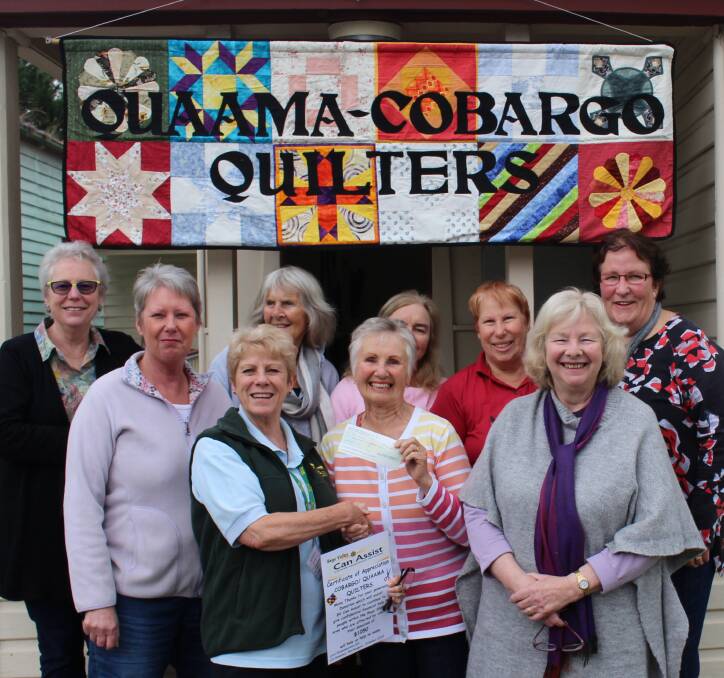 Lori Hammerton from Bega Valley Can Assist accepting the cheque from Quaama/Cobargo Quilters. (From left) Linda Butcher, Leanne Tett, Barbara Cameron, Joy Masterson, Ilse Whiffen, Robyn Allen, (front) Lori Hammerton, Mary Cooke, Michele Quah.
