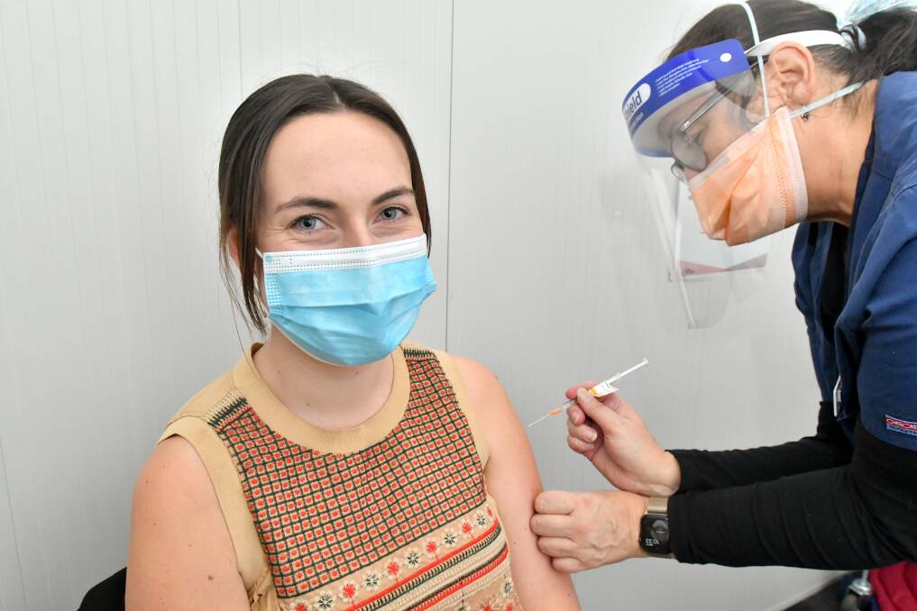 JAB: Kimberley Price, 25, receiving her AstraZeneca vaccine at Bendigo Health's Mollison Street Mass Vaccination Centre Picture: NONI HYETT