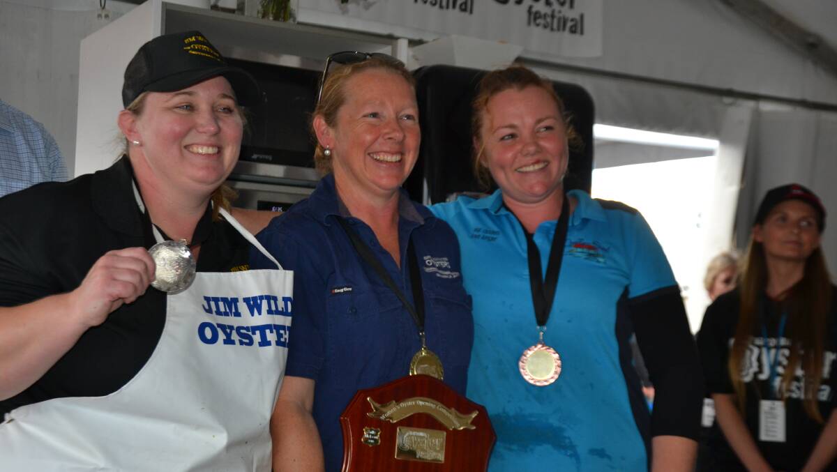 Women's oyster shucking competition winner Sue McIntyre (centre) with 2018 winner Sally McLean (left) and Jade Norris (right) at the Narooma Oyster Festival.
