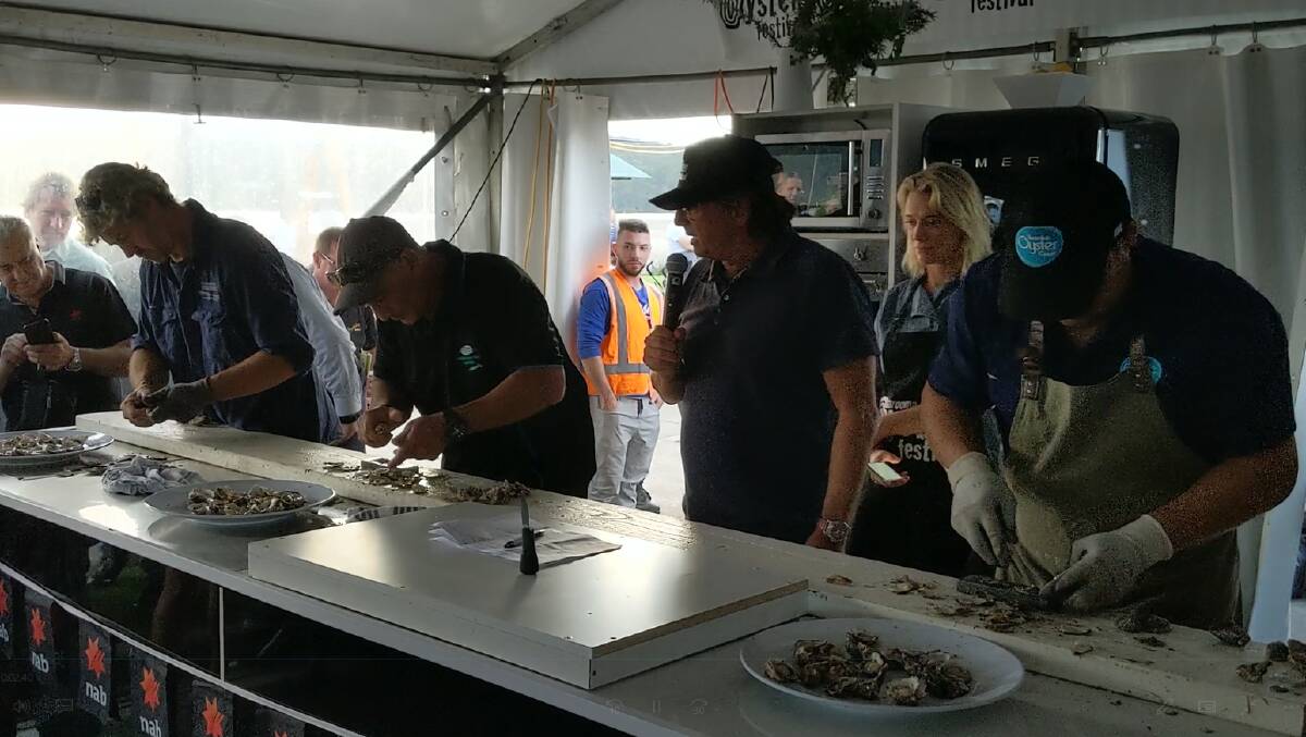 John Yiannaros (centre) on his way to winning the Narooma Oyster Festival men's shucking final for 2019.