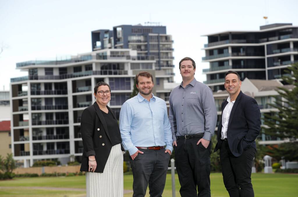 (Left to right) Kara Duncan from Walsh and Monaghan with graduate valuers Jed Davis and Lachlan Boyd, and George Papazoglou, course co-ordinator of the Bachelor in Property Valuation at TAFE NSW, pictured at Wollongong's foreshore. Picture by Adam McLean