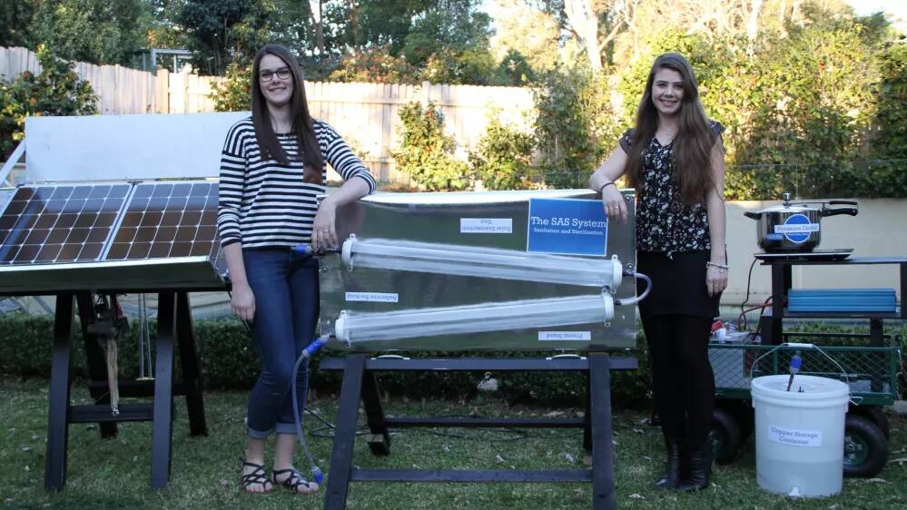TIGS student Macinley Butson (left) and Bega student Jade Moxey with their portable, self-sustainable water treatment invention. Photo: Martin Butson